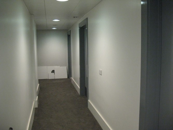 An internal corridor leading between changing rooms, toilets and th...